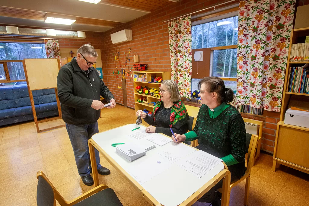 Seppo Lehto ennätti Vehmaalla ensimmäisenä ennakkoäänestyspaikalle, jossa häntä palvelivat Tarja Ahtiainen ja Tuija Suominen.